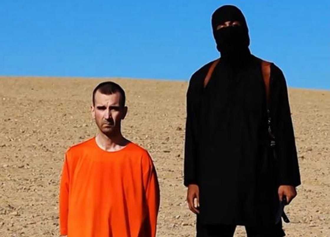 A frame grab from a video released by the Islamic State shows an IS militant holding a knife before purportedly executing British aid worker David Cawthorne Haines.